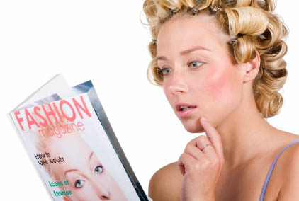 Woman in hair curlers reading fashion magazine. Magazine cover is fictional and has my image on it.